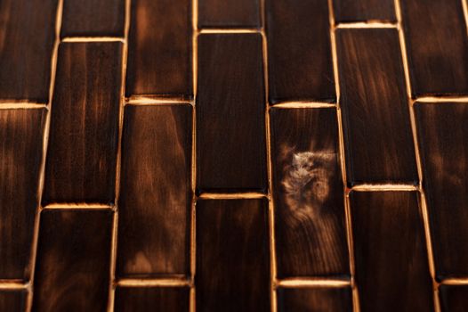 Wooden charred floor of small plates. Bottom view. Floor as an element of the interior.