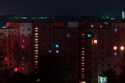 Night long exposure photo 9 and 10 floors high-rise buildings in red colours. Big city life is here!