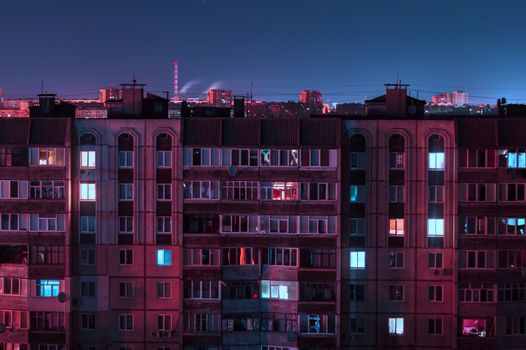 Night long exposure photo 9 and 10 floors high-rise buildings in purple colors. Big city life is here!
