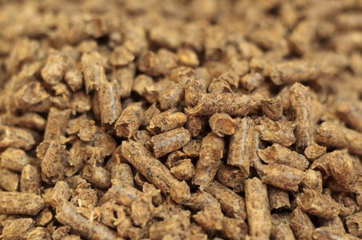 Fuel wood pellet close-up. A source of alternative clean energy. A lot of pellet. Natural fuel and energy of future.