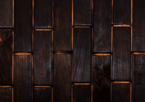 Wooden charred floor of small plates. View from above. Floor as an element of the interior.
