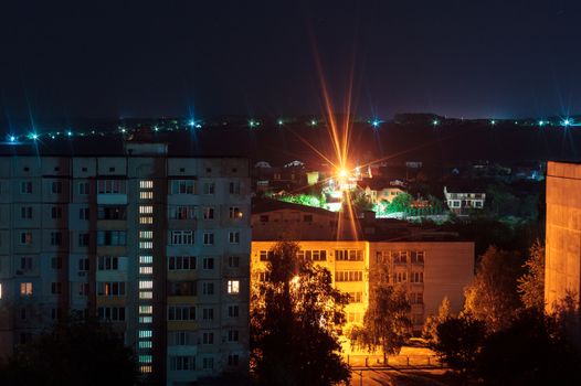 Night long exposure photo 9 and 10 floors high-rise buildings in blue and orange colours. Big city life is here!
