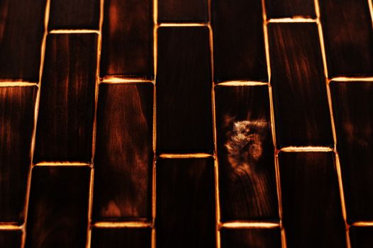 Wooden charred floor of small plates. Bottom view. Floor as an element of the interior.