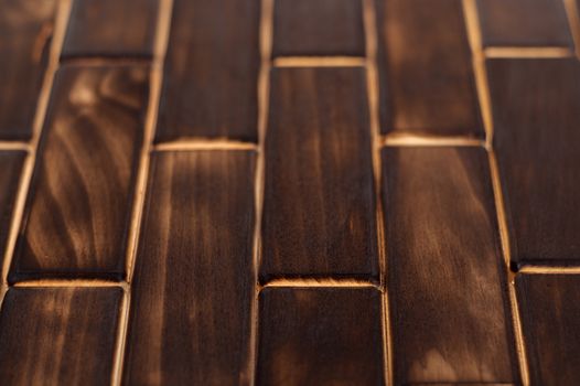 Wooden charred floor of small plates. Bottom view. Floor as an element of the interior.