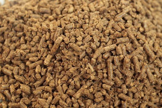 Fuel wood pellet close-up. A source of alternative clean energy. A lot of pellet. Natural fuel and energy of future.