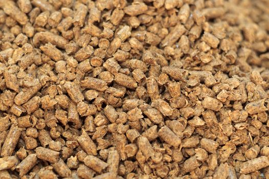 Fuel wood pellet close-up. A source of alternative clean energy. A lot of pellet. Natural fuel and energy of future.