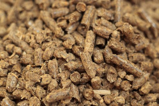 Fuel wood pellet close-up. A source of alternative clean energy. A lot of pellet. Natural fuel and energy of future.
