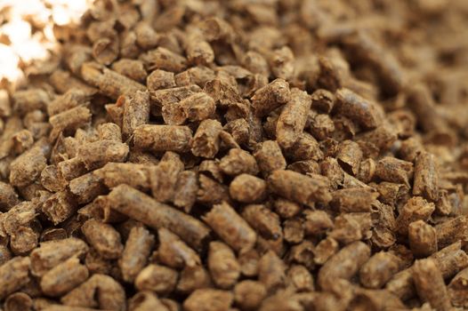 Fuel wood pellet close-up. A source of alternative clean energy. A lot of pellet. Natural fuel and energy of future.