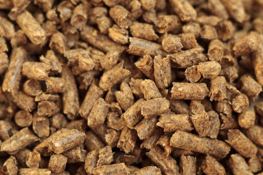 Fuel wood pellet close-up. A source of alternative clean energy. A lot of pellet. Natural fuel and energy of future.