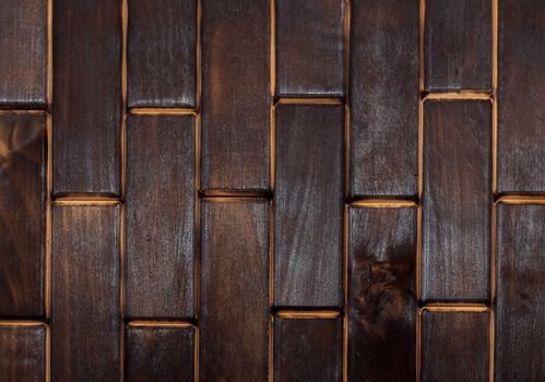 Wooden charred floor of small plates. View from above. Floor as an element of the interior.