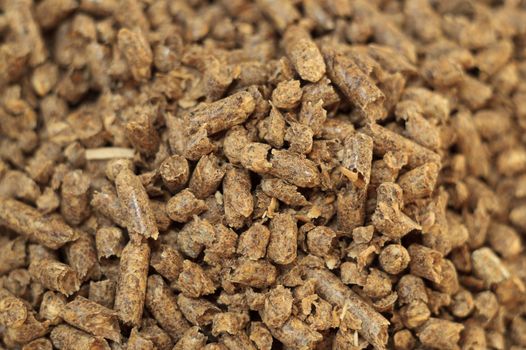 Fuel wood pellet close-up. A source of alternative clean energy. A lot of pellet. Natural fuel and energy of future.