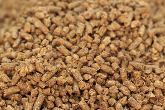 Fuel wood pellet close-up. A source of alternative clean energy. A lot of pellet. Natural fuel and energy of future.