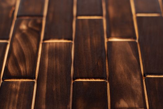 Wooden charred floor of small plates. Bottom view. Floor as an element of the interior.