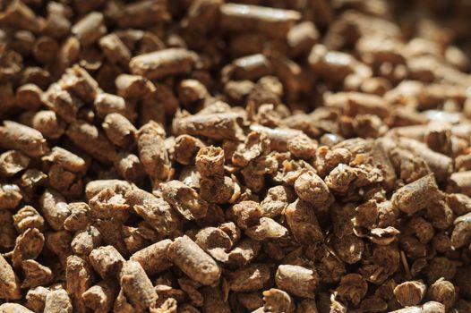 Fuel wood pellet close-up. A source of alternative clean energy. A lot of pellet. Natural fuel and energy of future.