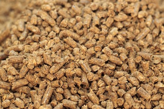 Fuel wood pellet close-up. A source of alternative clean energy. A lot of pellet. Natural fuel and energy of future.