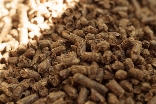 Fuel wood pellet close-up. A source of alternative clean energy. A lot of pellet. Natural fuel and energy of future.
