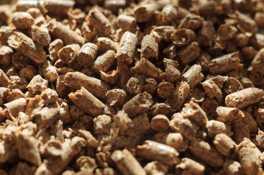 Fuel wood pellet close-up. A source of alternative clean energy. A lot of pellet. Natural fuel and energy of future.
