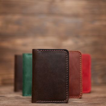 Soft focus photo of brown colour handmade leather cardholder. Blurred background on photo. Different colour cardholders blurred on background.