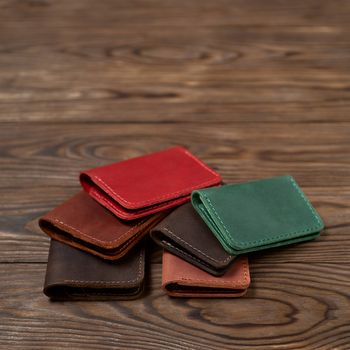 Six two-pocket leather handmade cardholder. Cardholders lies one on another. Stock photo on blurred background.