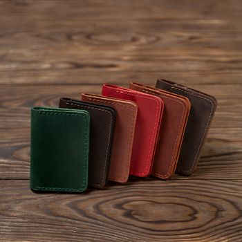 Six two-pocket leather handmade cardholder. Cardholders lies one on another. Stock photo on blurred background.