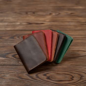 Six two-pocket leather handmade cardholder. Cardholders lies one on another. Stock photo on blurred background.