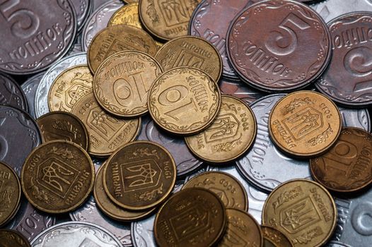 Small Ukrainian coins isolated on black background. Close-up view.