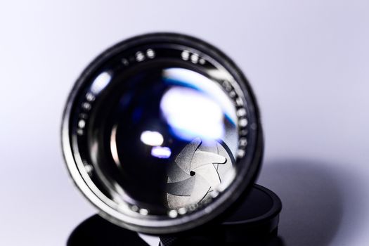 Vintage lens aperture closeup. Stock photo with blurred foreground.