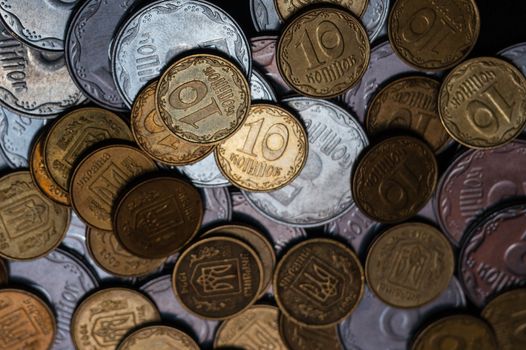 Small Ukrainian coins isolated on black background. Close-up view.