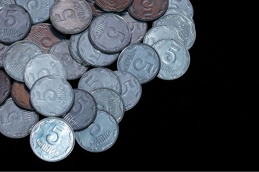 Small Ukrainian coins isolated on black background. Close-up view.
