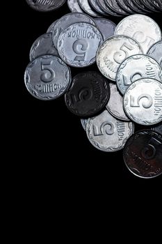 Ukrainian coins isolated on black background. Close-up view. Coins are located above the center of frame. A conceptual image.