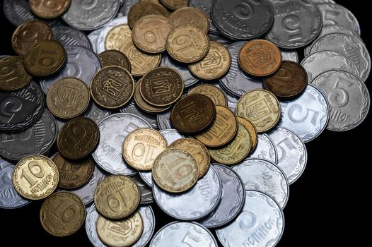 Ukrainian coins isolated on black background. Close-up view. Coins are located in the center of frame. A conceptual image.