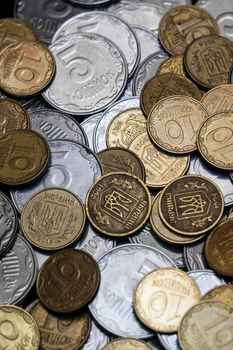 Ukrainian coins isolated on black background. Close-up view. Coins are located in the center of frame. A conceptual image.