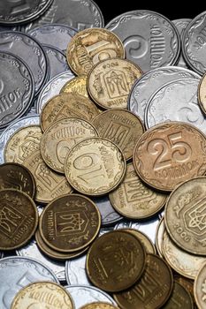 Ukrainian coins isolated on black background. Close-up view. Coins are located in the center of frame. A conceptual image.