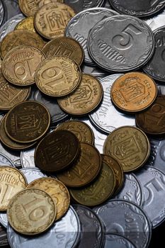 Ukrainian coins isolated on black background. Close-up view. Coins are located in the center of frame. A conceptual image.