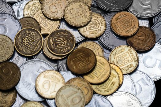 Ukrainian coins isolated on black background. Close-up view. Coins are located in the center of frame. A conceptual image.
