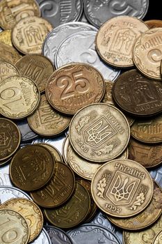 Ukrainian coins isolated on black background. Close-up view. Coins are located in the center of frame. A conceptual image.