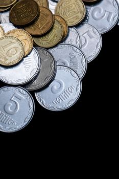 Ukrainian coins isolated on black background. Close-up view. Coins are located above the center of frame. A conceptual image.