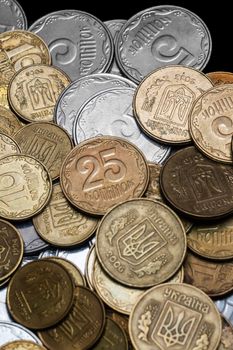 Ukrainian coins isolated on black background. Close-up view. Coins are located in the center of frame. A conceptual image.