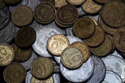 Ukrainian coins isolated on black background. Close-up view. Coins are located in the center of frame. A conceptual image.