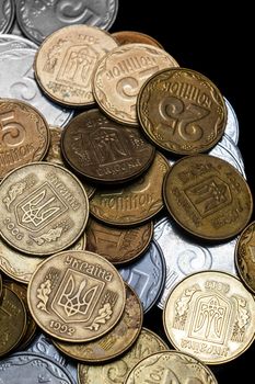 Ukrainian coins isolated on black background. Close-up view. Coins are located in the center of frame. A conceptual image.