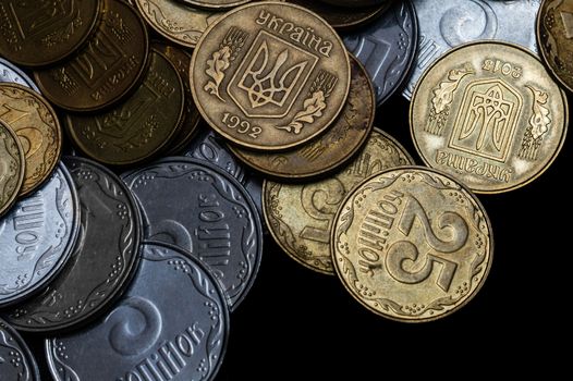 Ukrainian coins isolated on black background. Close-up view. Coins are located above the center of frame. A conceptual image.