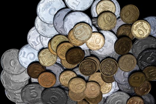 Ukrainian coins isolated on black background. Close-up view. Coins are located in the center of frame. A conceptual image.