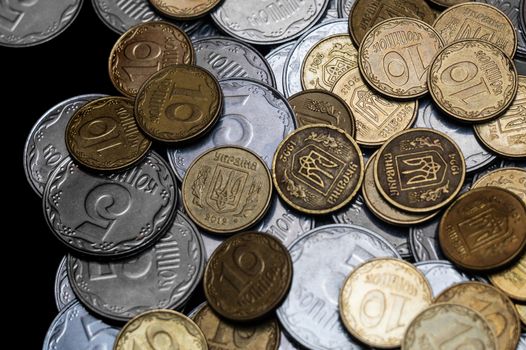 Ukrainian coins isolated on black background. Close-up view. Coins are located in the center of frame. A conceptual image.