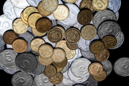 Ukrainian coins isolated on black background. Close-up view. Coins are located in the center of frame. A conceptual image.