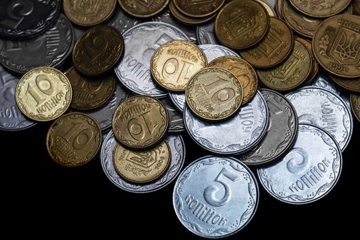 Ukrainian coins isolated on black background. Close-up view. Coins are located above the center of frame. A conceptual image.