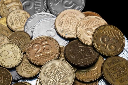 Ukrainian coins isolated on black background. Close-up view. Coins are located in the center of frame. A conceptual image.