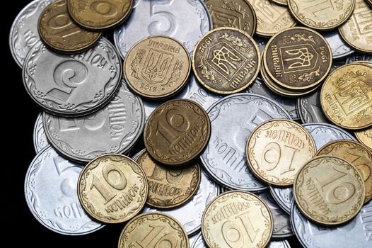 Ukrainian coins isolated on black background. Close-up view. Coins are located in the center of frame. A conceptual image.