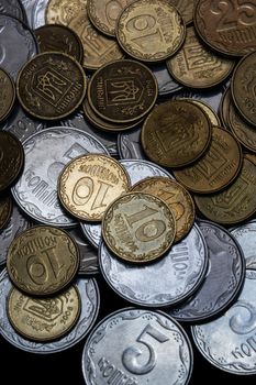 Ukrainian coins isolated on black background. Close-up view. Coins are located in the center of frame. A conceptual image.