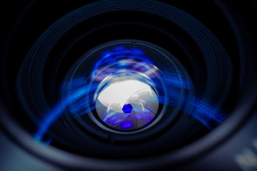 Lens aperture low light photo closeup. Blue traces on glass. Aperture blades is clean. Stock photo isolated on black background.