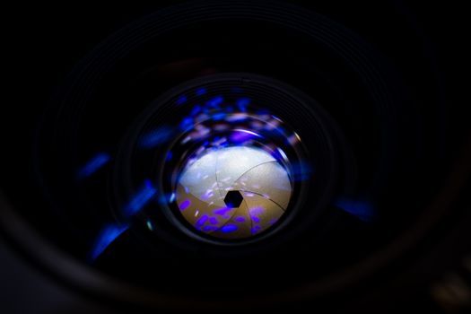 Lens aperture low light photo closeup. Blue traces on glass. Aperture blades is clean. Stock photo isolated on black background.
